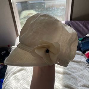 Cream colored hat. Their is also a knitted white colored head band.